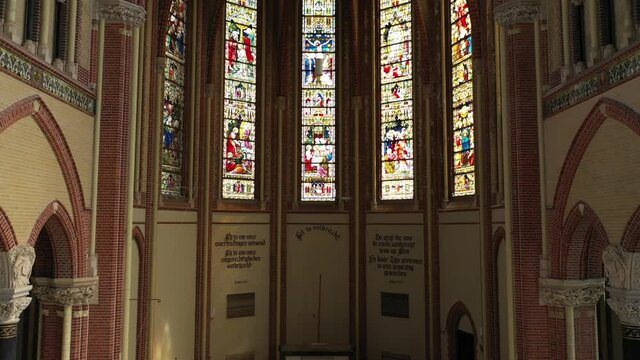 Interior Of Gouwekerk Church With Stained Glass Of Life Of Jesus In Gouda, Netherlands. - zoom in