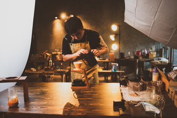 barista brewing a coffee filter drip in the morning, beverage drink with fresh black espresso aroma, hot drink in cup of cafes, brown caffeine in bar shop background