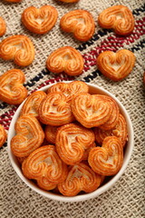 Fresh baked heart shaped cookies .