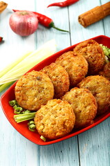 Fresh baked crispy and spicy meat cutlets. on a rustic kitchen table background.