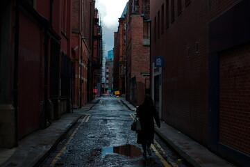 Women walking in a backstreet in the UK, England Manchester