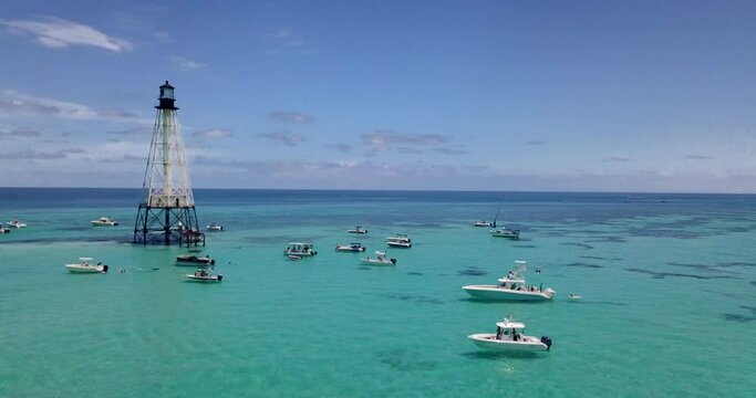 Drone over boats and Alligator Lighthouse in Islamorada, Florida Keys, in Atlantic Ocean. shot on Mavic Pro in 4k.