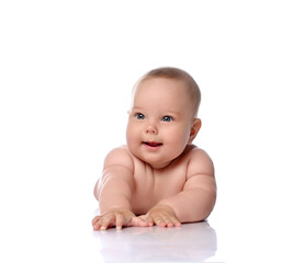 Happy, surprised, amazed infant child baby girl kid in diaper is lying on her stomach holding arm outstretched isolated on a white background