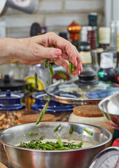 Chef dips asparagus into the crockery to make baked goods with asparagus and peas. Step by step recipe