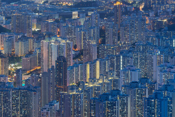 Aerial view of crowded residential building in Hong Kong city at night