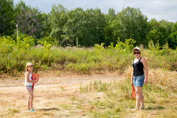 mother and daughter playing badminton