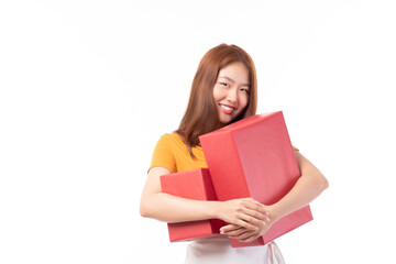 Attractive Asian woman holding gift box in christmas, new year, valentine day, birthday celebration concept. Portrait of smiling happy pretty girl hold gift box isolated on white with copy space.