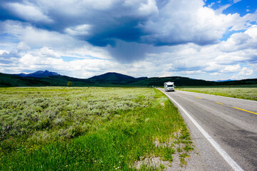 Fototapeta na wymiar road in the mountains, Yellowstone, national park, road, van, nature, scenery, blue skies, mountains