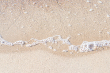 Soft wave of the sea on the sandy beach.Soft focus,blurred image.