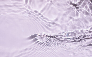 Pink liquid colored clear water surface texture with splashes bubbles with copy space. Trendy summer nature banner. Defocused water waves in sunlight background. 