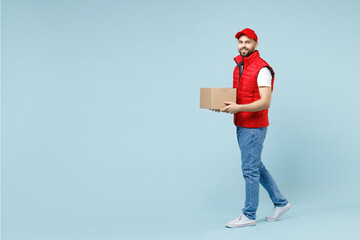 Full size body length delivery guy employee man in red cap white T-shirt vest uniform work as...