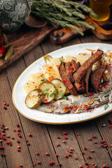 Traditional russian snacks with herring and pickles on wooden background