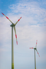 Two Wind turbines with blue sky background summer day.An environmentally friendly way to get electricity.