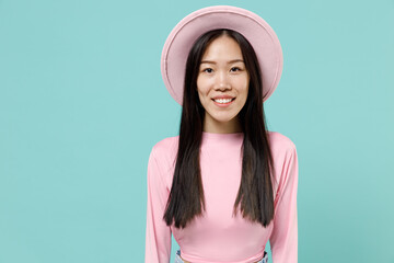 Naklejka premium Happy charismatic fascinating stunning fun young brunette asian woman 20s wear pink clothes hat look camera isolated on pastel blue color background studio portrait. People emotions lifestyle concept
