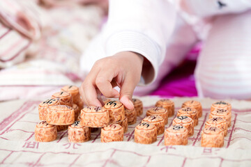 Children's hands are placing Chinese chess