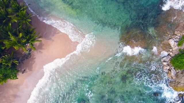 Aerial view shot of drone. Top-down view full frame beach sand and water texture and clear. Nature and travel concept. 4K UHD Video clip.