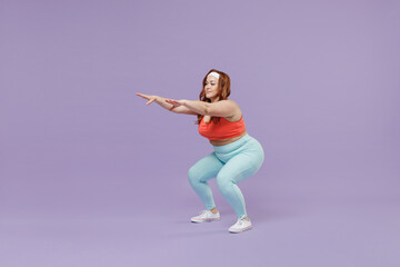 Fototapeta na wymiar Full length side view happy young chubby overweight plus size big fat fit woman wear red top warm up training squating isolated on purple background studio home gym. Workout sport motivation concept.