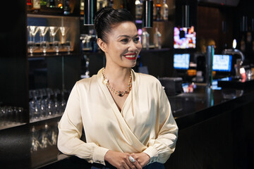 Attractive elegant woman attending cocktail party at restaurant