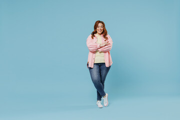 Full length young fun smiling redhead chubby overweight woman 30s with curly hair wear in pink...