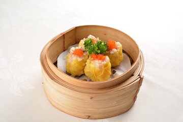 Hong Kong steamed siew mai meatball dumpling with wanton skin abalone and roe in bamboo basket asian dim sum menu