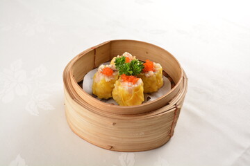 Hong Kong steamed siew mai meatball dumpling with wanton skin abalone and roe in bamboo basket asian dim sum menu