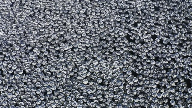 Small reflecting plates clustered together in a large water reservoir.