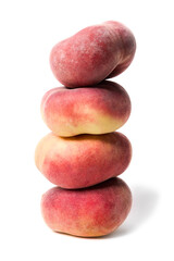 Heap of whole flat peaches stacked on top of each other isolated on white background. As design element.