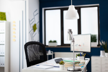 Modern office interior with nobody in it for business people to work. Inside view of stylish space of startup workplace corporate. Monitor with financial statistics and charts.