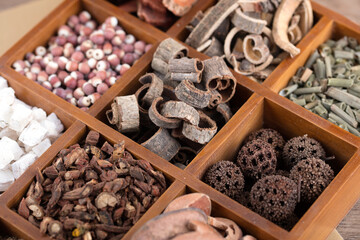 A variety of Chinese herbal medicines in a checkered wooden box