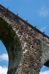 stone railroad bridge over sky