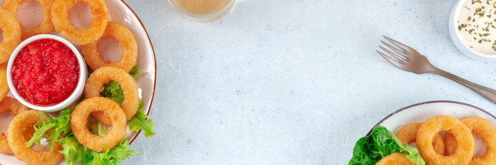 Calamari rings panorama. Squid rings banner with a place for text, a flat lay. Appetizer menu design template with copy space