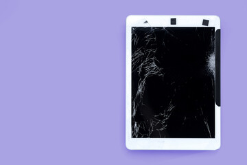 cracked or broken screen of smartphone or tablet temporarily fixed with black tape on purple pastel background, isolated object with clipping path