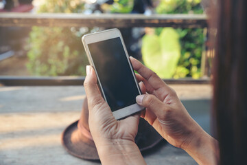 Woman's hand Using phone and touch screen at home. Technology concept.
