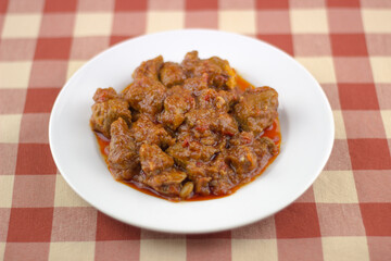 plato tipico de cerdo en salsa, typical spanish dish of pork in sauce