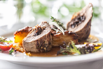 Pork tenderloin stuffed with prunes, reduction from red wine with potato gratin.