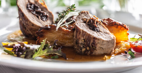 Pork tenderloin stuffed with prunes, reduction from red wine with potato gratin.