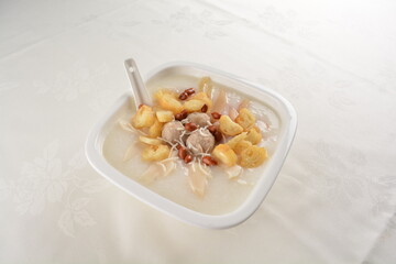teo chew double boiled white rice ting zai porridge congee with meatball, you tiao, peanut and vegetable in square bowl asian dim sum menu