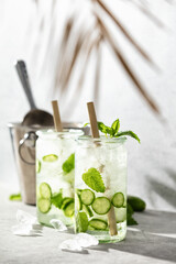 Summer sparklers, cucumber iced cocktail, hard light and shadows and tropical palm leaf