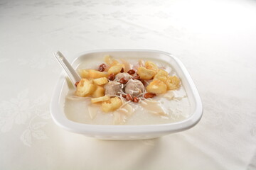 teo chew double boiled white rice ting zai porridge congee with meatball, you tiao, peanut and vegetable in square bowl asian dim sum menu