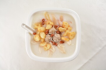 teo chew double boiled white rice ting zai porridge congee with meatball, you tiao, peanut and vegetable in square bowl asian dim sum menu