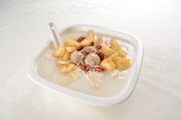 teo chew double boiled white rice ting zai porridge congee with meatball, you tiao, peanut and vegetable in square bowl asian dim sum menu