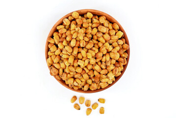 Salted and toasted corn in a terracotta bowl. White background