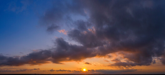 Dawn or sunset over the clouds, blue hour, aerial view.