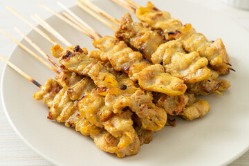 Pork satay with peanut sauce pickles which are cucumber slices and onions in vinegar