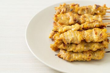 Pork satay with peanut sauce pickles which are cucumber slices and onions in vinegar