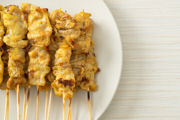 Pork satay with peanut sauce pickles which are cucumber slices and onions in vinegar