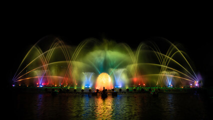 Fototapeta na wymiar colorful fountain dancing in celebration of year with dark night sky background.