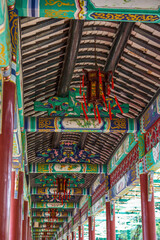 Fototapeta premium Chinese traditional corridor with painted palace lanterns in Baomo Garden, Guangzhou, China