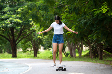 Asian women leg on surf skate or skate board. Sport activity lifestyle concept, Healthy and exercise.