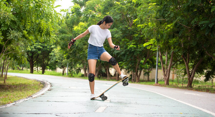 Asian women leg on surf skate or skate board